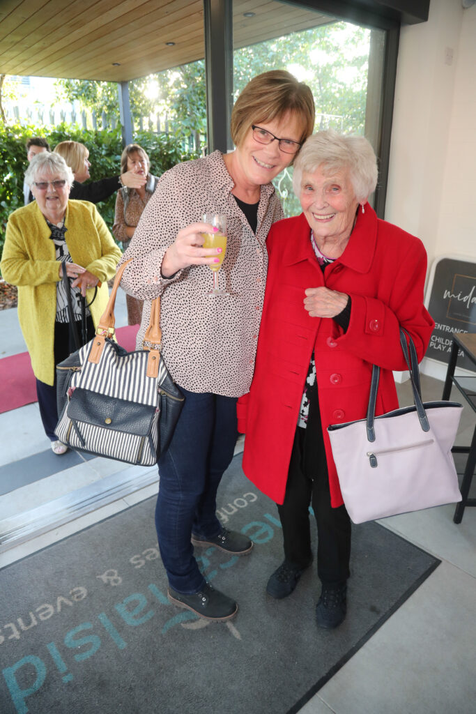 Two lady's posing for a photograph at the Star Awards 2022