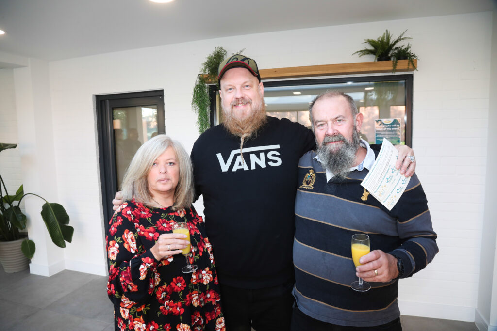 Three people posing for a photograph at the Star Awards 2022