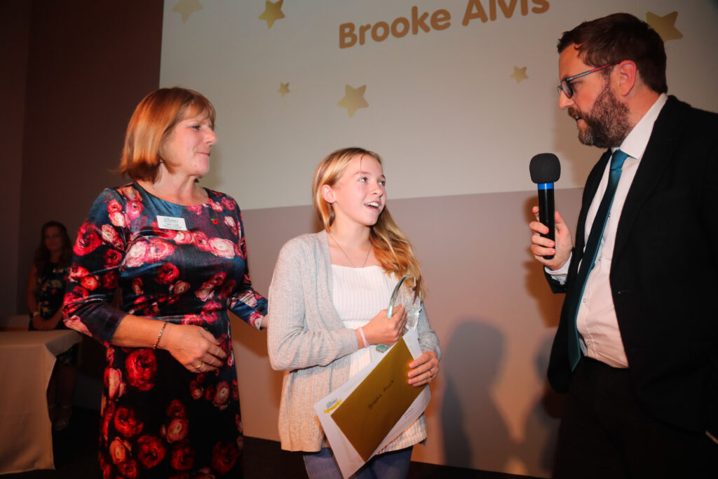 Young Hero of The Year Winner collecting her prize from the host