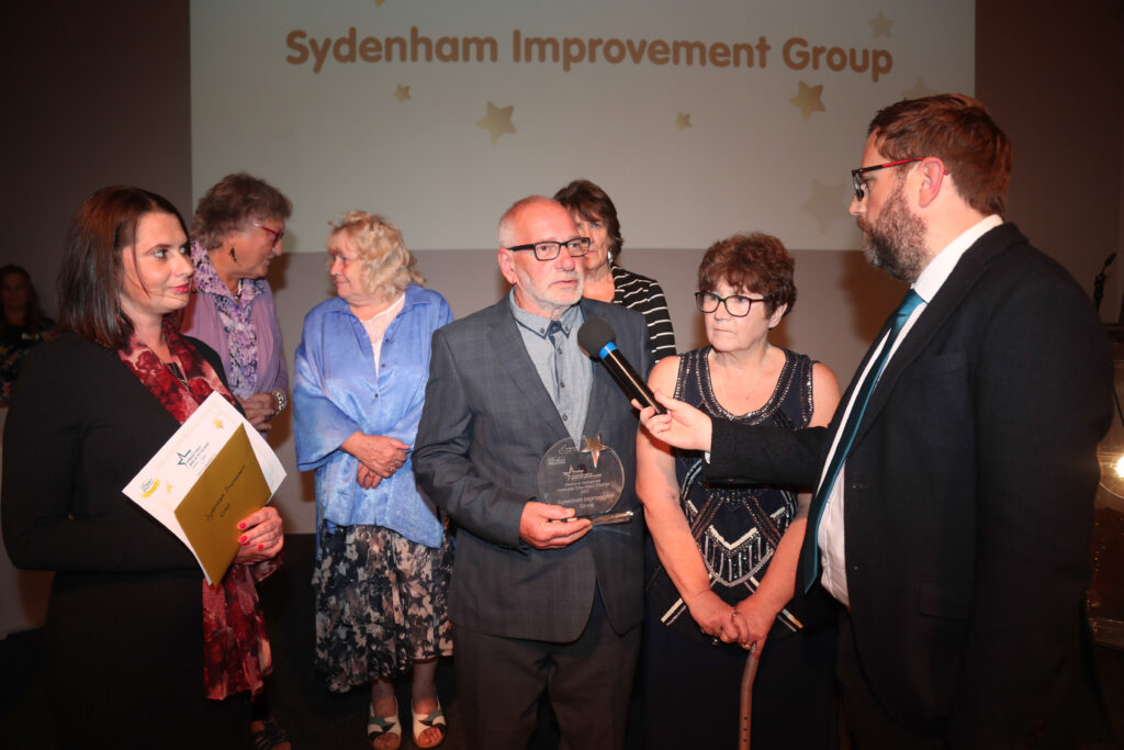 A group of people from the Sydenham Improvement Group accepting the Community Impact of The Year Award at the Star Awards 2022.