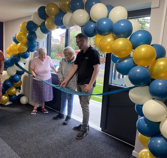 Homes in Sedgemoor colleagues and customers cutting a ribbon at the Chichester Close Communal Hall Opening